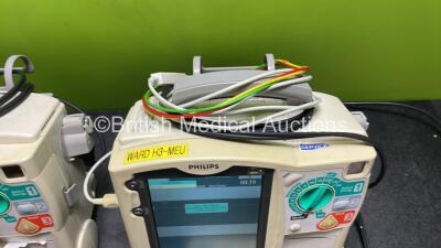 2 x Philips Heartstart MRx Defibrillators / Monitors Including ECG, and Printer Options (Both Power Up) with 1 x 3 Lead ECG Lead, 1 x Philips M3725A Test Load, 2 x Paddle Leads and 2 x Philips M3539A Modules - 6