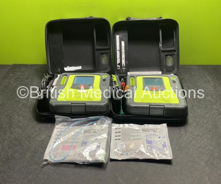 2 x Zoll AED PRO Defibrillators (Both Power Up) with 2 x 3 Lead ECG Leads, 2 x Batteries and 2 x Electrode Packs (Both In Date) in Carry Cases