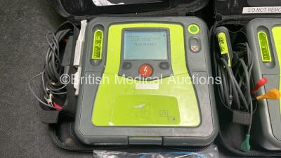 2 x Zoll AED PRO Defibrillators (Both Power Up) with 2 x 3 Lead ECG Leads, 2 x Batteries and 2 x Electrode Packs (Both In Date) in Carry Cases - 2