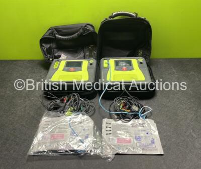 2 x Zoll AED PRO Defibrillators (Both Power Up with Damage to Screen - See Photos) with 2 x 3 Lead ECG Leads, 2 x Batteries and 2 x Electrode Packs (Both In Date) in Carry Cases