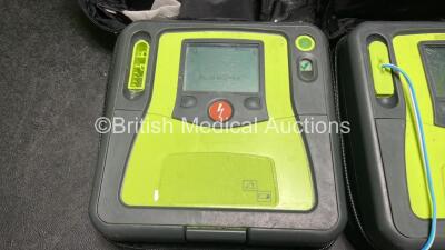 2 x Zoll AED PRO Defibrillators (Both Power Up with Damage to Screen - See Photos) with 2 x 3 Lead ECG Leads, 2 x Batteries and 2 x Electrode Packs (Both In Date) in Carry Cases - 2