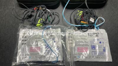 2 x Zoll AED PRO Defibrillators (Both Power Up with Damage to Screen - See Photos) with 2 x 3 Lead ECG Leads, 2 x Batteries and 2 x Electrode Packs (Both In Date) in Carry Cases - 7