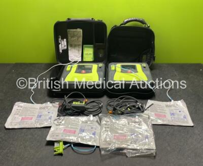 2 x Zoll AED PRO Defibrillators (Both Power Up with Damage to Screen, 1 x Crack in Casing - See Photos) with 2 x 3 Lead ECG Leads, 2 x Batteries and 4 x Electrode Packs (3 In Date, 1 Expired) in Carry Cases