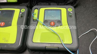 2 x Zoll AED PRO Defibrillators (Both Power Up with Damage to Screen, 1 x Crack in Casing - See Photos) with 2 x 3 Lead ECG Leads, 2 x Batteries and 4 x Electrode Packs (3 In Date, 1 Expired) in Carry Cases - 5