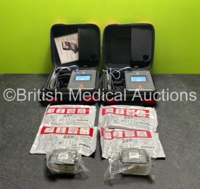 2 x Philips Heartstart FR3 Defibrillators (Both Power Up) In Carry Cases with 4 x Electrode Packs (2 In Date, 2 Expired) and 4 x Batteries (Install Before 2026 / 2026 / 2026 / 2022)