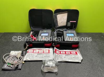 2 x Philips Heartstart FR3 Defibrillators (Both Power Up) In Carry Cases with 1 x ECG Lead, 2 x Electrode Packs (Both In Date) and 3 x Batteries (Install Before 2025 / 2026 / 2022)