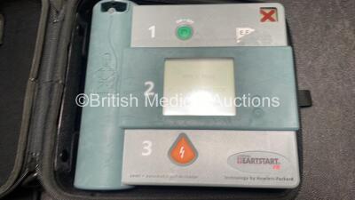 Job Lot Including 1 x Laerdal Heartstart FR Defibrillator with 1 x Battery and 1 x Heartstream Forerunner Defibrillator with 1 x Battery in Carry Cases (Both Power Up with Low Batteries) *SN 000015311 / 000005442*