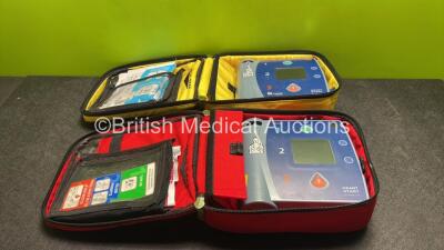 Job Lot Including 1 x Laerdal Heartstart FR2+ Defibrillator and 1 x Philips Heartstart FR2+ Defibrillator with 2 x Batteries and 3 x Electrode Packs (All Expired) in Carry Cases (Both Power Up) *SN 1204136119 / 1006212653*