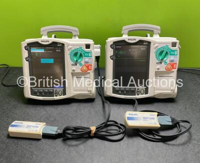 2 x Philips Heartstart MRx Defibrillators / Monitors Including ECG, and Printer Options (Both Power Up) with 2 x Philips M3725A Test Loads, 2 x Paddle Leads and 2 x Philips M3539A Modules