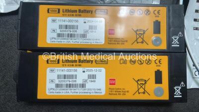 2 x Medtronic Physio Control Lifepak 1000 Defibrillators (Both Power Up with Cracks In Casing - See Photos) with 2 x ECG Leads, 2 x Electrode Packs (1 in Date, 1 Expired) and 2 x Batteries *Install Before 2025 / 2024* in Carry Cases - 8