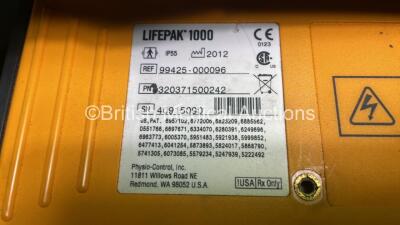 2 x Medtronic Physio Control Lifepak 1000 Defibrillators (Both Power Up with Cracks In Casing - See Photos) with 2 x ECG Leads, 2 x Electrode Packs (1 in Date, 1 Expired) and 2 x Batteries *Install Before 2025 / 2024* in Carry Cases - 9