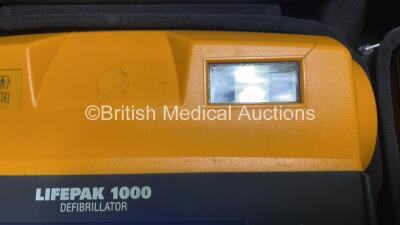 2 x Medtronic Physio Control Lifepak 1000 Defibrillators (Both Power Up with Cracks In Casing - See Photos) with 2 x ECG Leads, 2 x Electrode Packs (Both In Date) and 2 x Batteries *Install Before 2023 / 2024* in Carry Cases - 5