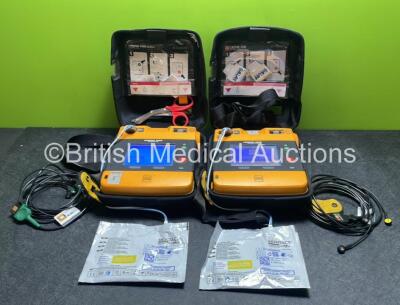 2 x Medtronic Physio Control Lifepak 1000 Defibrillators (Both Power Up with Cracks In Casing - See Photos) with 2 x ECG Leads, 2 x Electrode Packs (Both In Date) and 2 x Batteries *Install Before 2024 / 2024* in Carry Cases