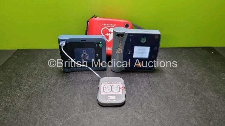 Job Lot Including 1 x Philips Heartstart FRx Defibrillator (Powers Up) In Carry Case with 2 x M5070A Batteries *Exp 2019 / 2024* 1 x Heartstart Smart Pads *Exp 2024* and 1 x Philips Heartstart FR2+ Defibrillator (Powers Up) with 1 x Battery