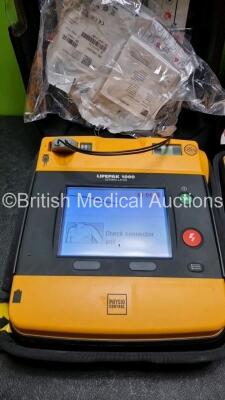 2 x Medtronic Physio Control Lifepak 1000 Defibrillators *Mfd 2013* (Both Power Up 1 x with Crack in Casing - See Photo) *SN 41245150 / 41245149* - 2