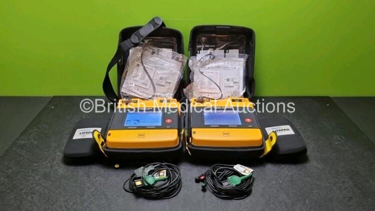 2 x Medtronic Physio Control Lifepak 1000 Defibrillators *Mfd 2013* (Both Power Up) with 2 x 3 Lead ECG Leads *SN 41245152 / 41245151*