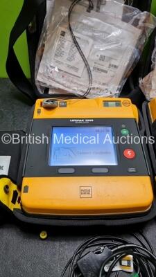 2 x Medtronic Physio Control Lifepak 1000 Defibrillators *Mfd 2013* (Both Power Up) with 2 x 3 Lead ECG Leads *SN 41245152 / 41245151* - 4