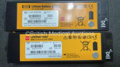 2 x Medtronic Physio Control Lifepak 1000 Defibrillators (Both Power Up with Cracks In Casing - See Photos) with 2 x Electrode Packs (Both In Date) and 2 x Batteries *Install Before 2025 / 2026* in Carry Cases - 7