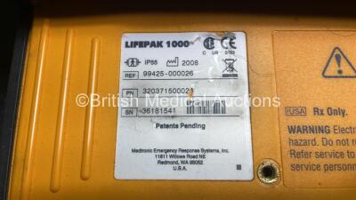 2 x Medtronic Physio Control Lifepak 1000 Defibrillators (Both Power Up with Cracks In Casing - See Photos) with 2 x Electrode Packs (Both In Date) and 2 x Batteries *Install Before 2025 / 2026* in Carry Cases - 8