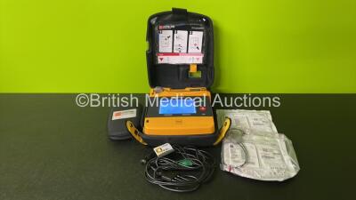 Medtronic Physio Control Lifepak 1000 Defibrillator (Powers Up - Some Marks to Screen) with 1 x ECG Lead, 2 x Electrode Packs (In Date) and Battery in Carry Case *44823376*