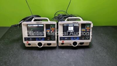 2 x Physio Control Medtronic Lifepak 20e Defibrillators / Monitors (Both Power Up Both Missing Door) Including Pacer, ECG and Printer Options with 2 x Paddle Lead and 2 x 3 Lead ECG Leads