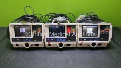 3 x Physio Control Medtronic Lifepak 20e Defibrillators / Monitors (All Power Up 1 x Missing Door) Including ECG and Printer Options with 3 x Paddle Lead and 3 x 3 Lead ECG Leads