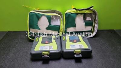 2 x Zoll AED PRO Defibrillators (1 x Powers with Stock Battery Stock Battery Not Included, 1 x No Power, Both with Light Scratches On Screen) In Carry Case