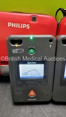 2 x Philips Heartstart FR3 Defibrillators (Both Power Up) In Carry Cases with 2 x Batteries *Install Before - 2025 / 2028* and 3 x In Date Electrode Packs - 3