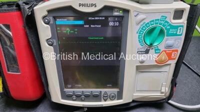 Philips Heartstart MRx Defibrillator (Powers Up) Including Pacer ,ECG, SpO2 NIBP and Printer Options with External Paddle Dock with External Hard Paddles, 1 x Paddle Lead, 1 x 3 Lead ECG Lead, 1 x Philips M3725A Test Load, 1 x Philips M3538A Battery and 1 - 2