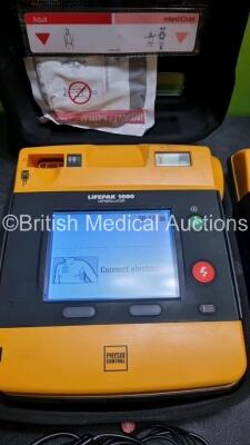 2 x Medtronic Physio Control Lifepak 1000 Defibrillators *Mfd - 2012* (Both Power Up) - 2