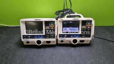 Job Lot Including 1 x Physio Control Medtronic Lifepak 20e Defibrillator / Monitor (No Power, Loose Casing - See Photo) and 1 x Physio Control Medtronic Lifepak 20e Defibrillator / Monitor (Powers Up) with 2 x Paddle Leads