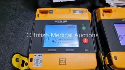 2 x Medtronic Physio Control Lifepak 1000 Defibrillators *Mfd - 2011 / 2014* (Both Power Up Both with Slight Crack In Casing - See Photos) - 3