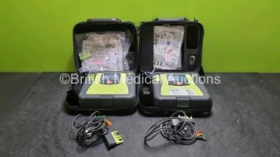 2 x Zoll AED PRO Defibrillators (Both Power Up, Both with Scratches On Screen - See Photo) In Carry Case with 2 x 3 Lead ECG Leads, 2 x Batteries and 2 x In Date Electrode Packs