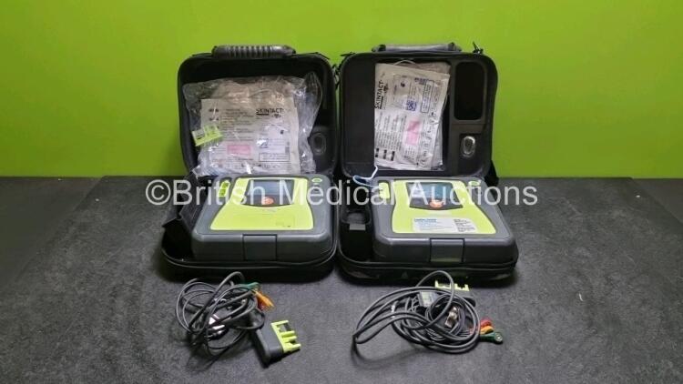 2 x Zoll AED PRO Defibrillators (Both Power Up, Both with Scratches On Screen - See Photo) In Carry Case with 2 x 3 Lead ECG Leads, 2 x Batteries and 2 x In Date Electrode Packs