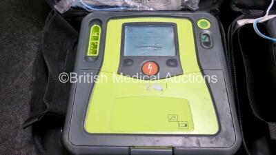 2 x Zoll AED PRO Defibrillators (Both Power Up, Both with Scratches On Screen - See Photo) In Carry Case with 2 x 3 Lead ECG Leads, 2 x Batteries and 2 x In Date Electrode Packs - 3