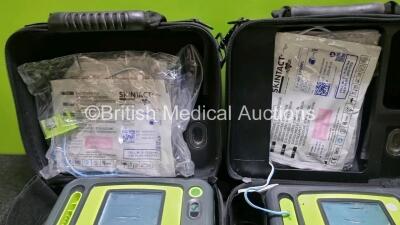 2 x Zoll AED PRO Defibrillators (Both Power Up, Both with Scratches On Screen - See Photo) In Carry Case with 2 x 3 Lead ECG Leads, 2 x Batteries and 2 x In Date Electrode Packs - 5