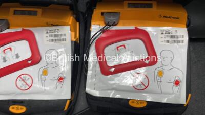 2 x Medtronic Lifepak CR Plus Defibrillators (Both Power Up) with 2 x Electrode Packs *Both Expired* in Carry Cases and 2 x Medtronic Mounting Brackets - 6