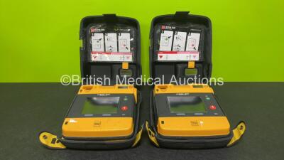 2 x Medtronic Physio Control Lifepak 1000 Defibrillators *Mfd 2014* (Both Power Up with Stock Battery Stock Battery Not Included) In Case