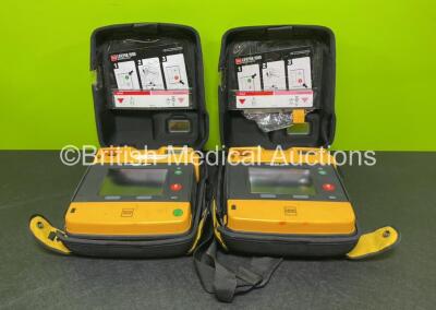 2 x Medtronic Physio Control Lifepak 1000 Defibrillators *Mfd 2014* (Both Power Up with Stock Battery Stock Battery Not Included) In Case