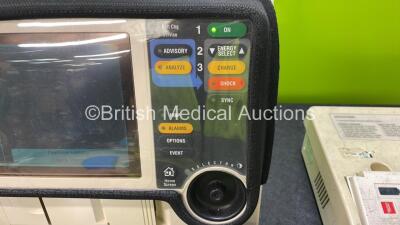 Medtronic Lifepak 12 Biphasic Defibrillator Including ECG, NIBP, Printer and SpO2 Options with 2 Batteries, 1 x ECG Lead, 1 x Test Load, 1 x Paddle Lead, 1 x Electrode Pack and 1 x Physio Control Battery Support System 2 with 3 x Batteries (Both Power Up) - 3