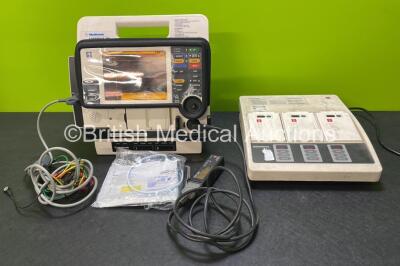 Medtronic Lifepak 12 Biphasic Defibrillator Including Pacer, ECG and Printer Options with 2 Batteries, 1 x ECG Lead, 1 x Test Load, 1 x Paddle Lead, 1 x Electrode Pack and 1 x Physio Control Battery Support System 2 with 3 x Batteries (Both Power Up)