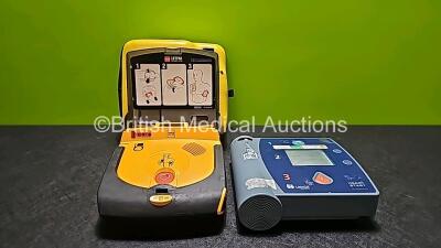 1 x Laerdal Heartstart FR2+ Automated External Defibrillator with 1 x Battery and 1 x Medtronic Lifepak CR Plus Defibrillator with 1 x Battery (Both Power Up)