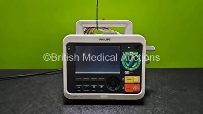 Philips Efficia DFM100 Defibrillator *Mfd 2018* Including ECG and Printer Options Release Rev 2.0 with 1 x 3 Leads ECG Lead (Powers Up, Missing Battery and Missing Paddle Lead Connector Cap - See Photo)