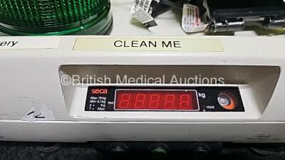 Mixed Lot Including 1 x Verathon BladderScan BVI9000 Series Calibration Tank, 1 x Seca Weighing Scale, 1 x Welch Allyn Stethoscope, 1 x ConMed Footswitch, 2x Braun ThermoScan Thermometers, 1 x Green Emergency 12v Light and 1 x Blue Emergency 12v Light - 6