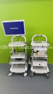 2 x Olympus Stack Trolleys with Olympus OEV261H Monitor, Olympus Evis Lucera CV-260 Digital Processor, Olympus MAJ-1154 Pigtail Connector and Olympus Evis Lucera CLV-260 Light Source (Powers Up)