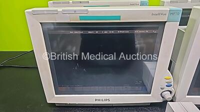 4 x Philips IntelliVue MP70 Patient Monitors with 2 x Philips IntelliBridge EC10 Modules (All Power Up, 1 x Cracked Case and 1 x Missing Dial - See Photo) *SN DE84381763 / DE73165265 / DE84381769 / DE35015194* - 3