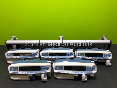 4 x Cardinal Health Alaris CC Syringe Pumps and 1 x Unknown CareFusion Alaris Syringe Pump (1 x Damaged Casing and 1 x Missing Casing - See Photos) with 1 x Alaris DS Gateway Workstation *SN 800338736 / 800338716 / 800356498 / 800356539 / 800338854*