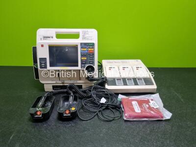 Job Lot Including 1 x Medtronic Lifepak 12 Biphasic Defibrillator (Powers Up) Including Pacer, ECG and Printer Options with 2 x Batteries Apex / Sternum External Hard Paddles, 3 Lead ECG Lead, AC Power Adaptor and Medtronic Battery Support System 2 Charg