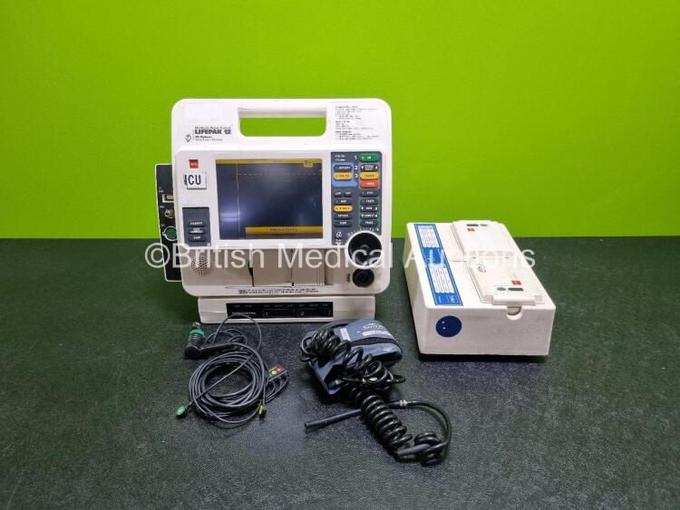 Job Lot Including 1 x Medtronic Lifepak 12 Biphasic Defibrillator (Powers Up) Including Pacer, ECG, SpO2, NIBP and Printer Options with 2 x Batteries, 3 Lead ECG Lead, AC Power Adaptor (No Power) and Elektonic Mobile Battery Service Station (Powers Up) w