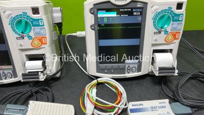 2 x Philips Heartstart MRx Defibrillators (Both Power Up) Including ECG and Printer Options, 2 x Paddle Leads, 2 x Test Loads, 2 x 3 Lead ECG Leads, 2 x Philips M3539A Modules and 2 x Philips M3538A Li-Ion Batteries *SN US00583345 / US00584766* - 4